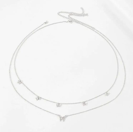 Silver necklace with small pendants on a white background