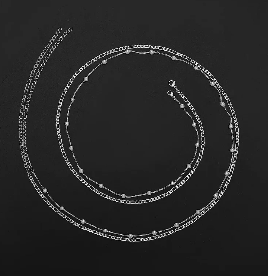 Silver chain necklace on a black background