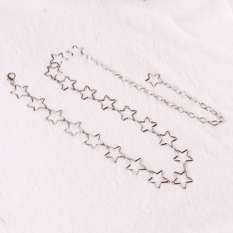 Silver star-shaped necklace on a light pink background