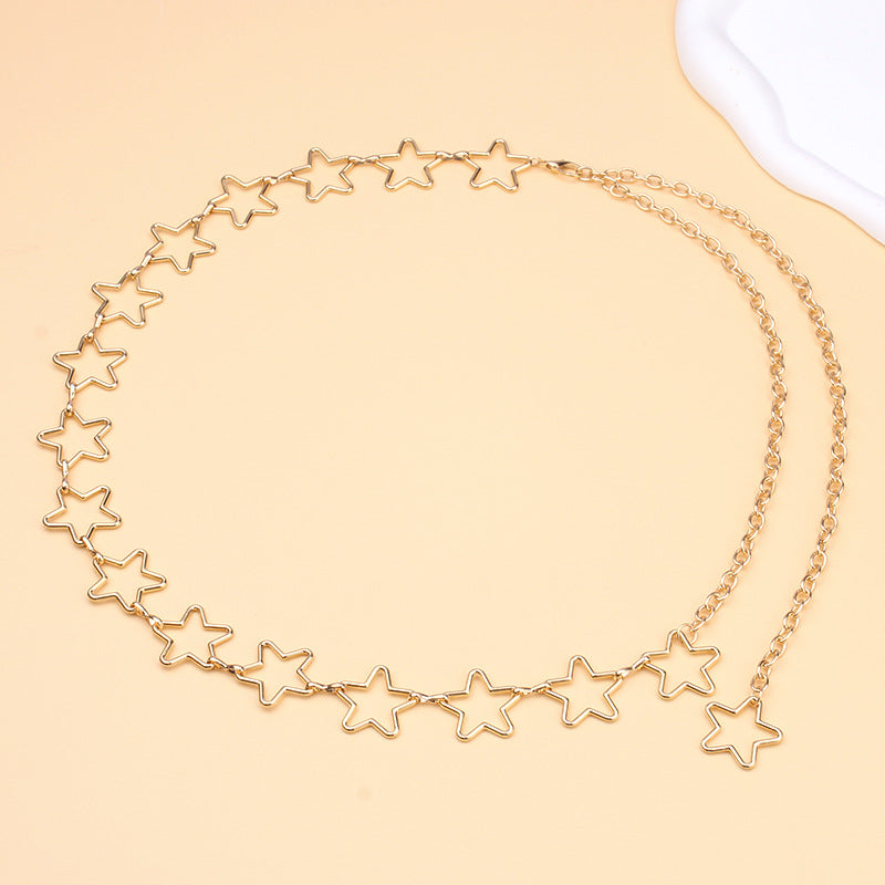 Gold star-shaped necklace on a beige background